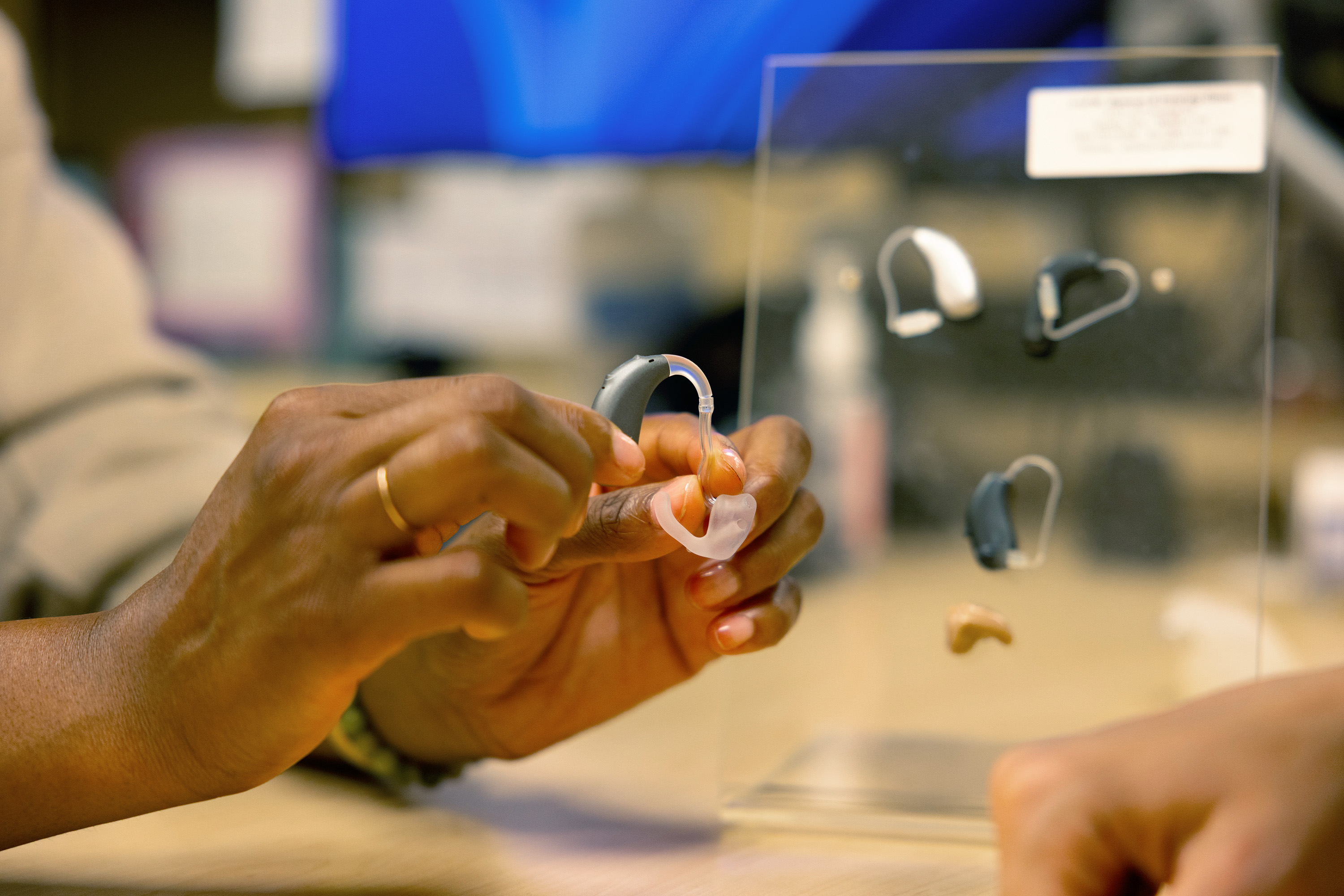 Hearing aid being shown by a clinician to a patient