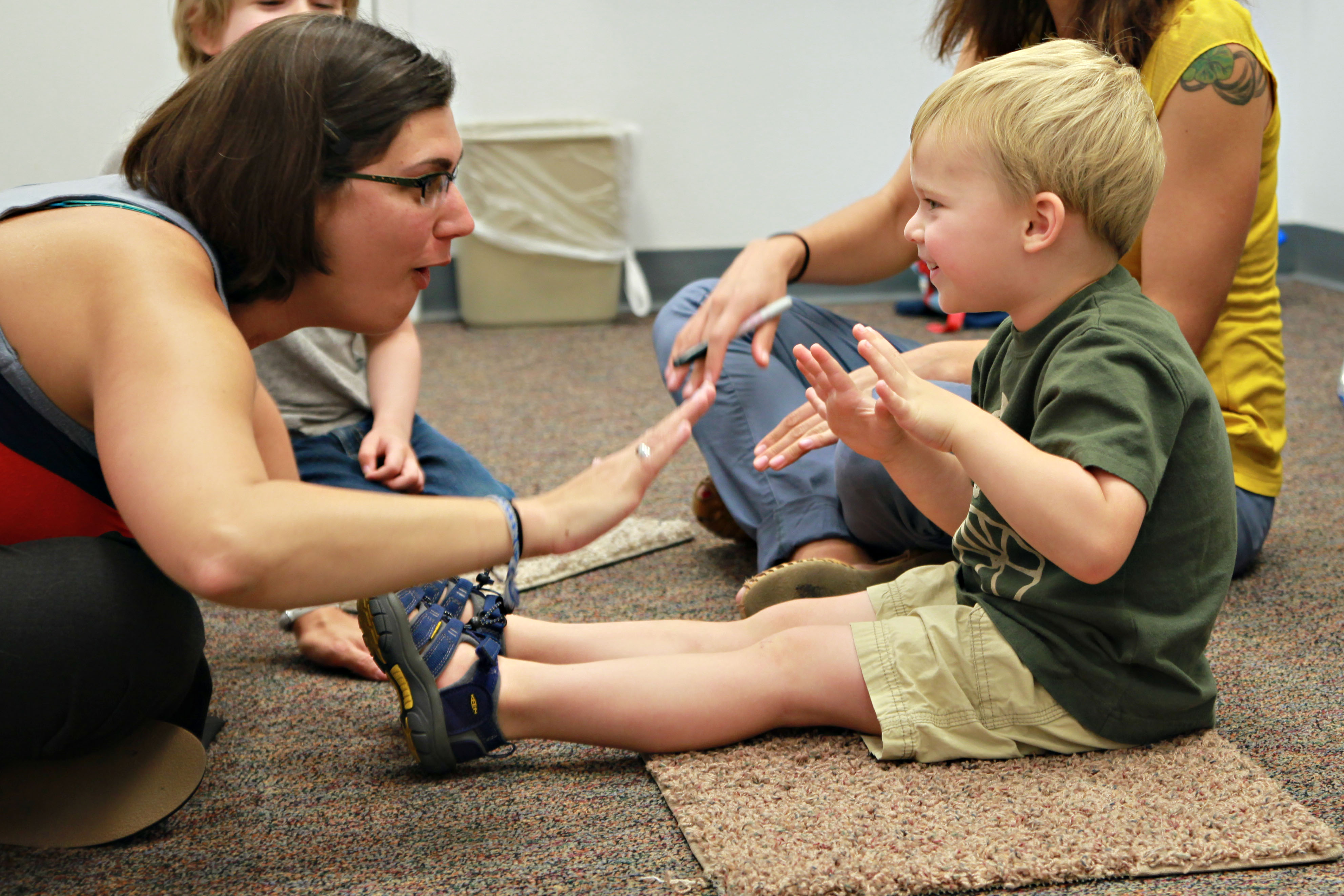 Clinician working with a young boy in a speech and hearing clinic